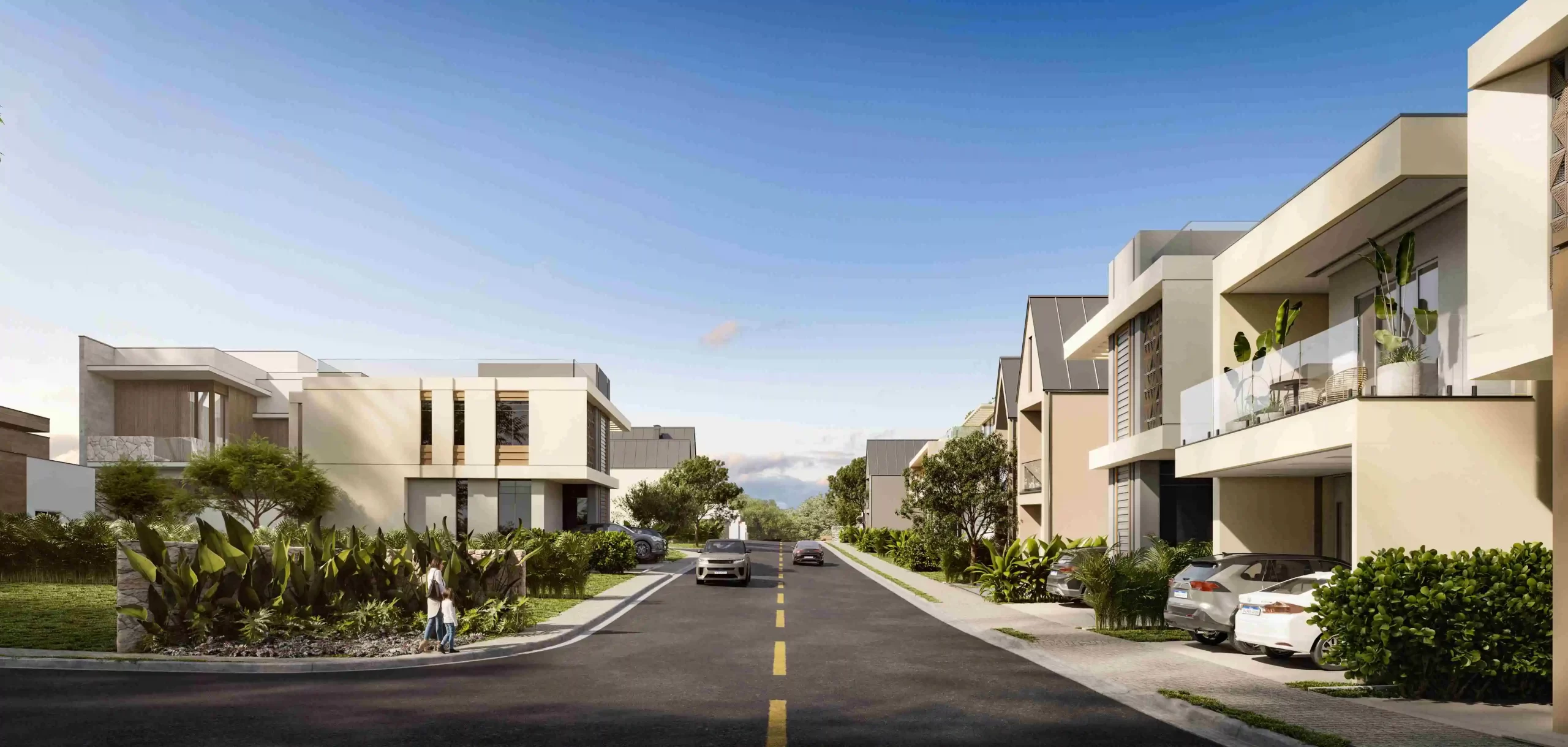 Rua residencial moderna em um condomínio fechado, com casas contemporâneas, áreas verdes e ambiente tranquilo em dia ensolarado.