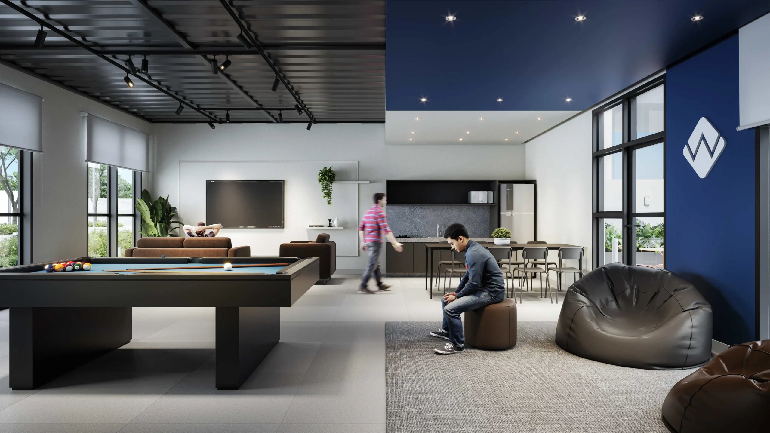 Área de lazer moderna em condomínio empresarial com mesa de sinuca, lounge confortável e cozinha integrada, ideal para promover bem-estar e produtividade em ambientes corporativos.